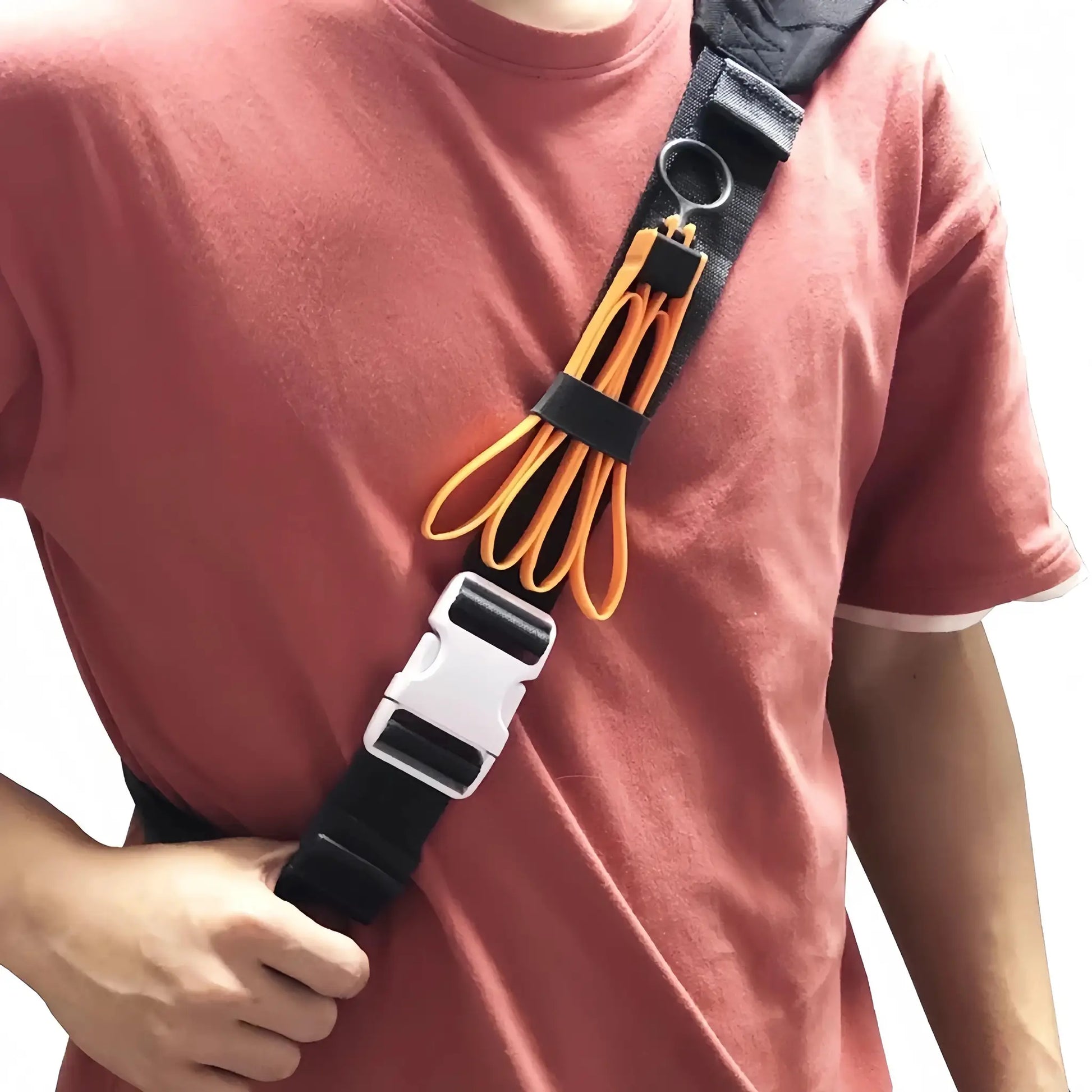 Tactical plastic restraint cable ties, yellow, looped on a black gear strap worn across the chest.