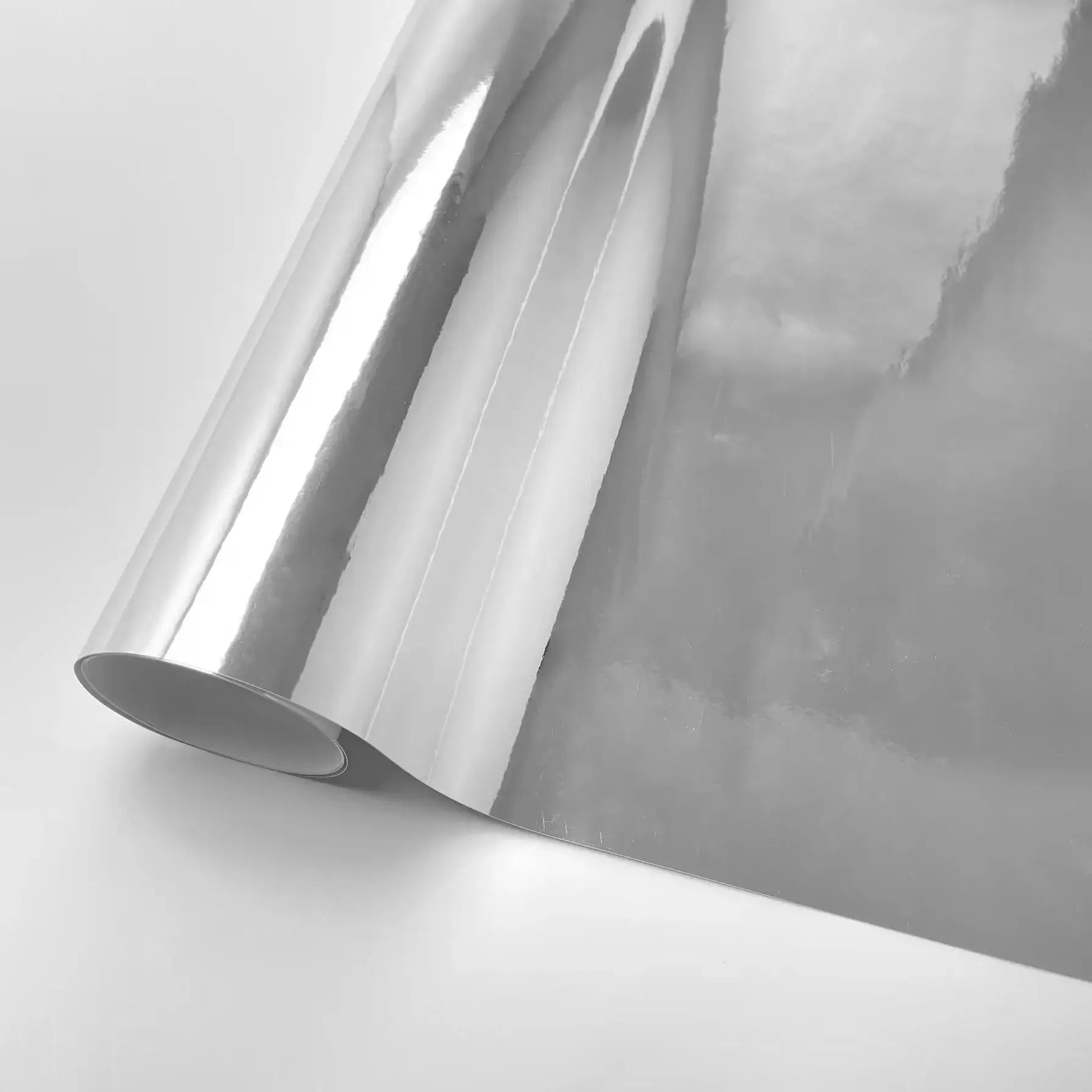 Stretchable silver chrome vinyl wrap roll for cars and motorcycles, reflective mirror finish.
