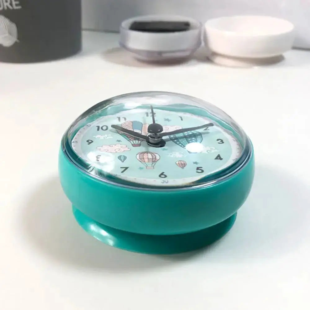 Mini teal table clock with clear dome, anti-fog waterproof quartz, 7cm diameter.