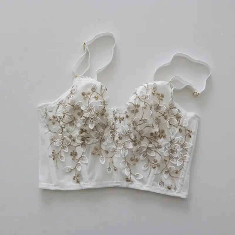 Three-dimensional embroidered white lace bralette by Simples Market with gold floral embroidery.