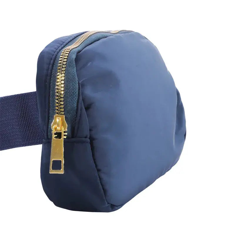 Waist bag in navy nylon with gold zipper and adjustable strap