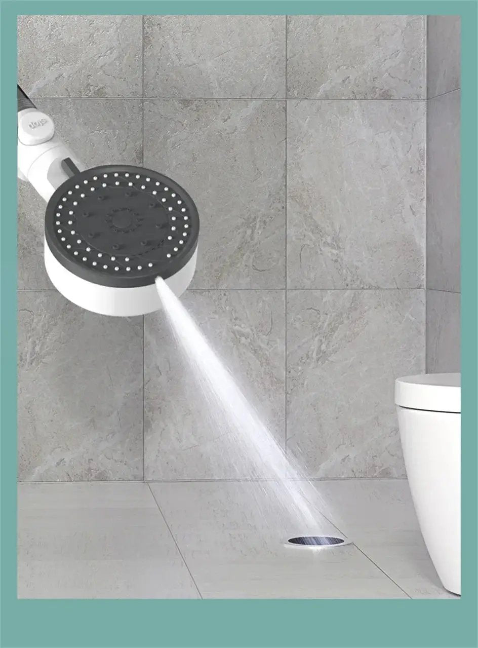 10-mode handheld showerhead with white body and black face, high-pressure spray toward a floor drain.