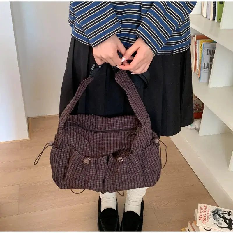 Korean nylon plaid shoulder bag by Simples Market with zipper pockets and drawstring accents