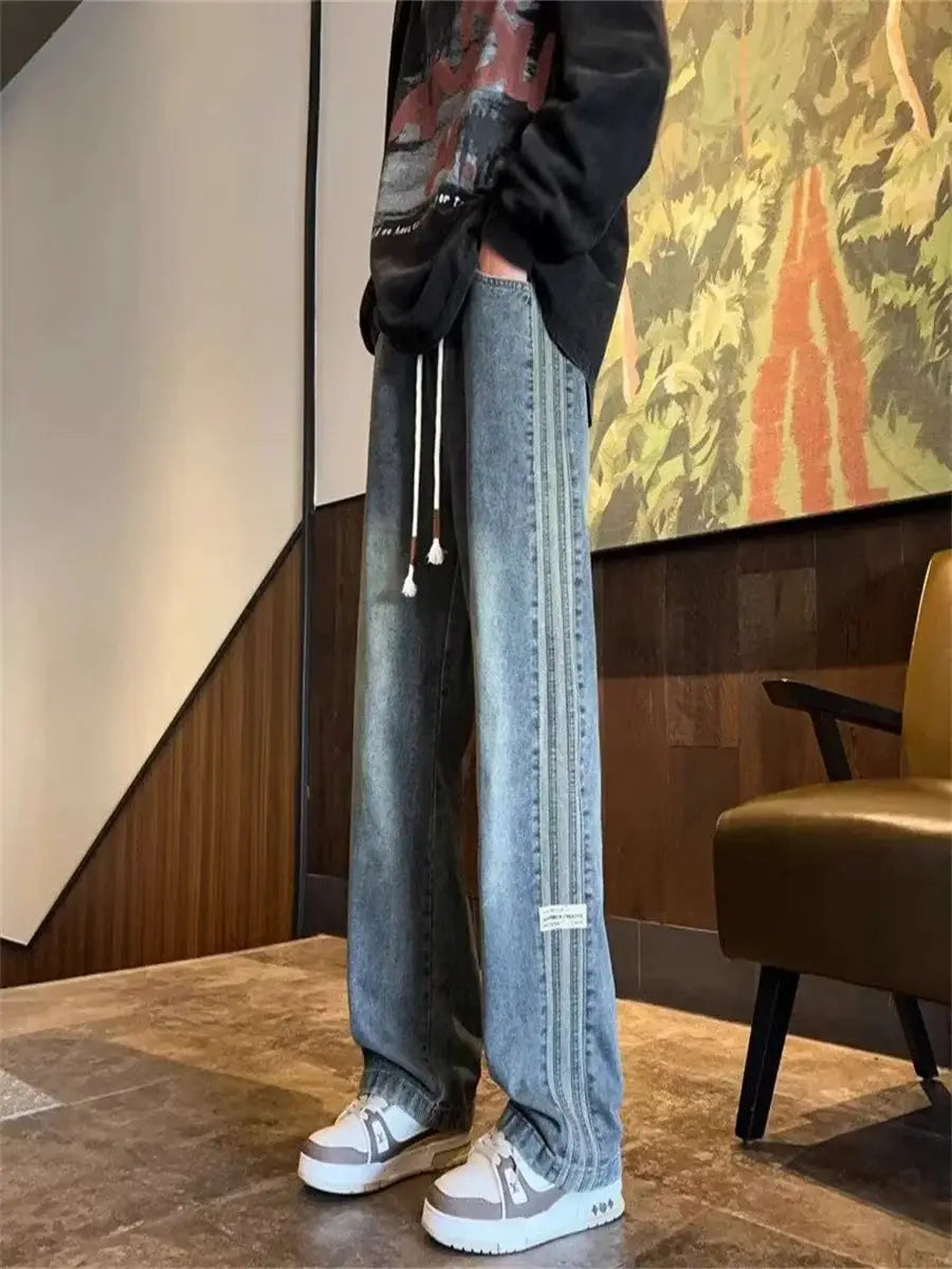 Men's light blue denim jeans with elastic waist, drawstring, loose straight leg and triple stripe side detailing