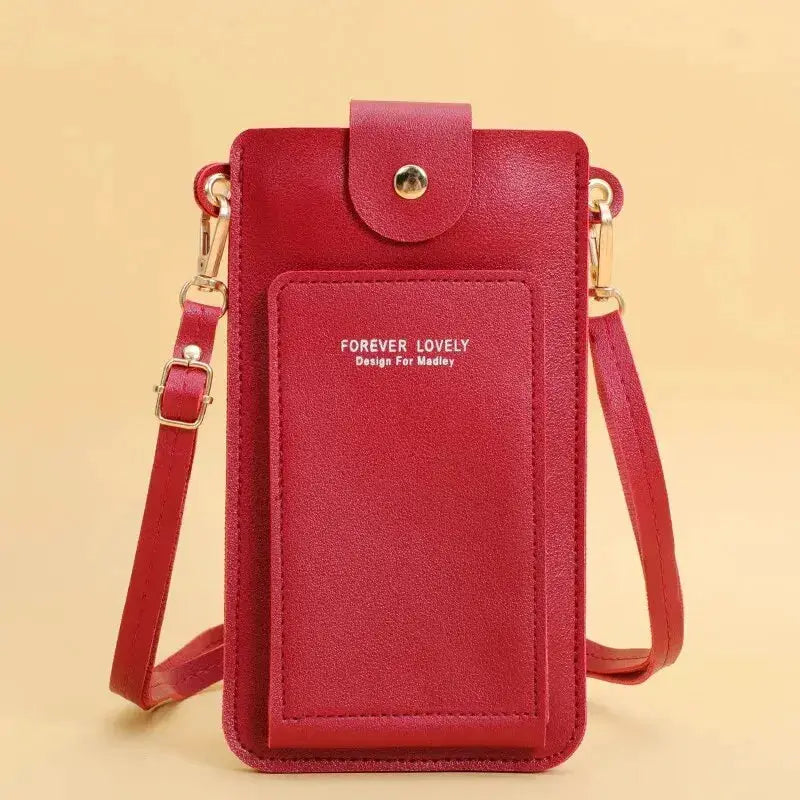 Women's red soft leather crossbody bag with front pocket, gold hardware, and adjustable strap