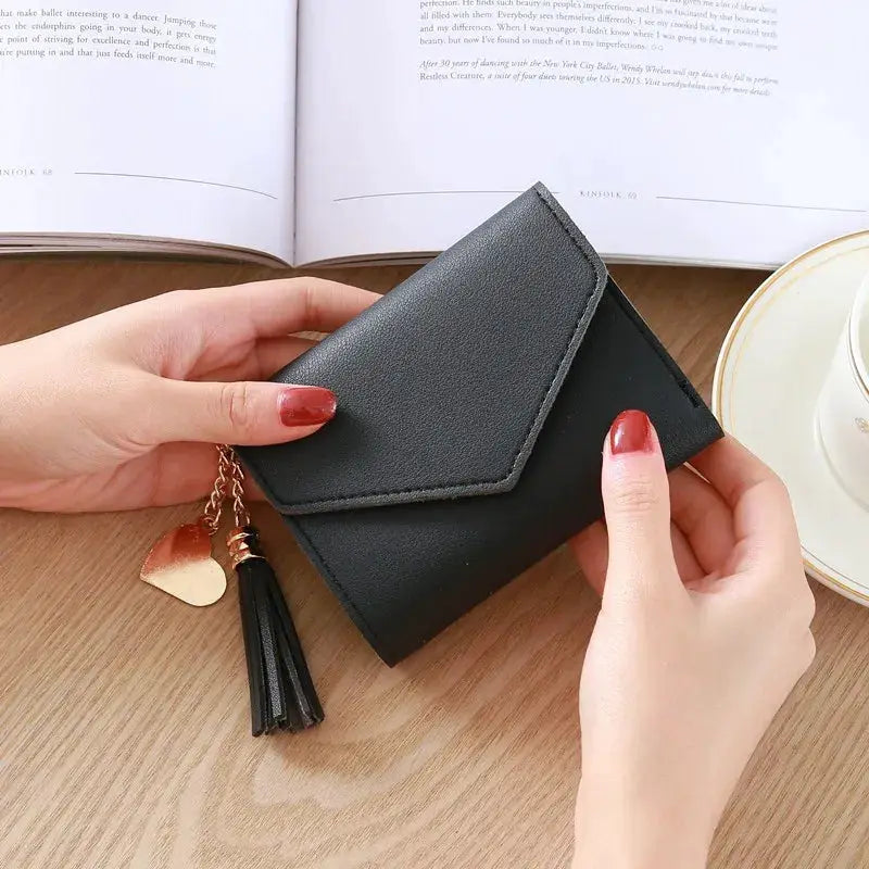 Black PU leather wallet with envelope-style flap and tassel charm