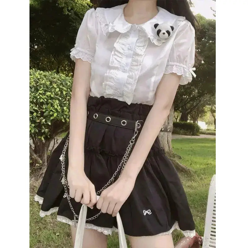 Deeptown Kawaii Lolita blouse: white lace top with puff sleeves and ruffles, paired with a black high-waisted skirt