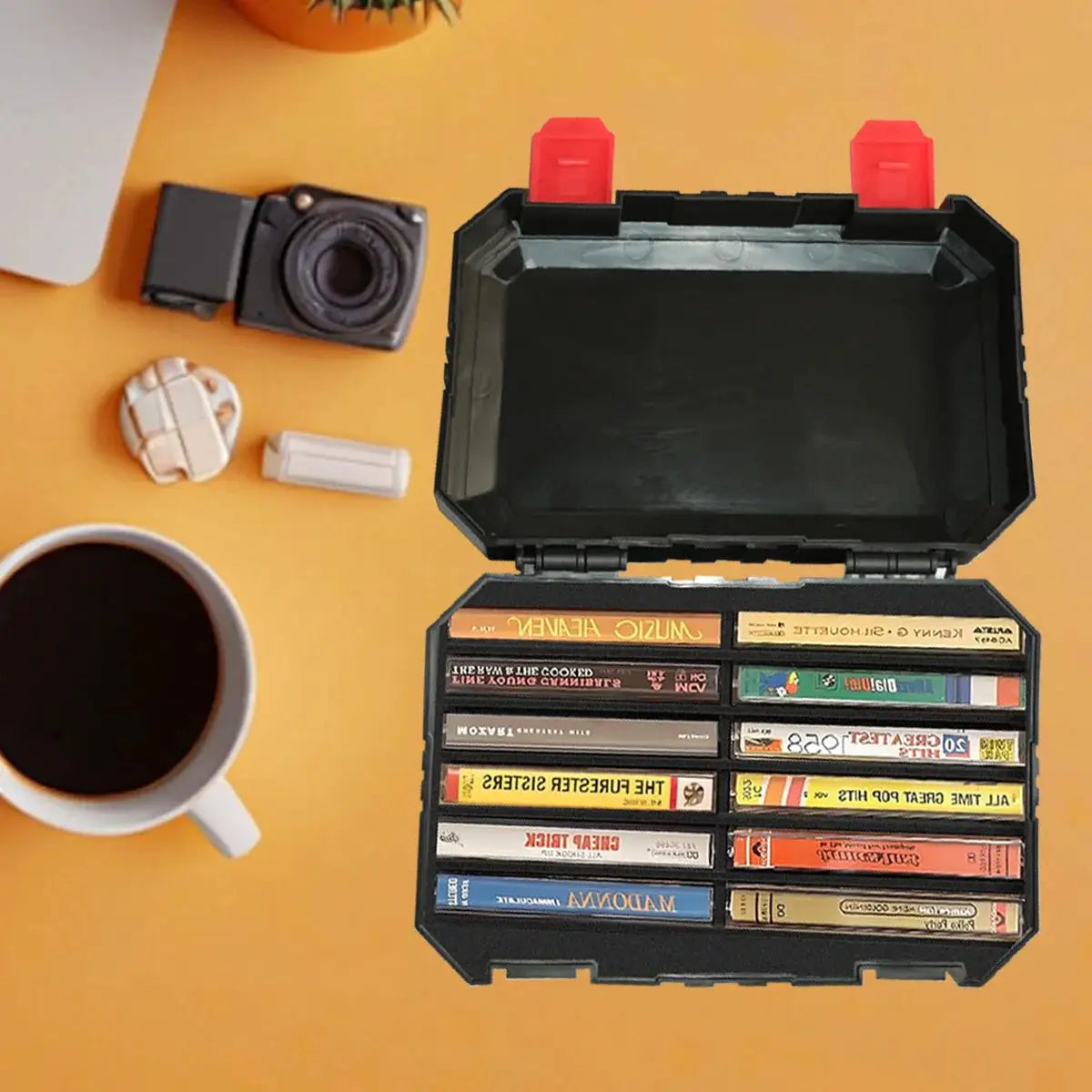 Simples Market black plastic storage box with red latches, opened to hold cassette tapes.