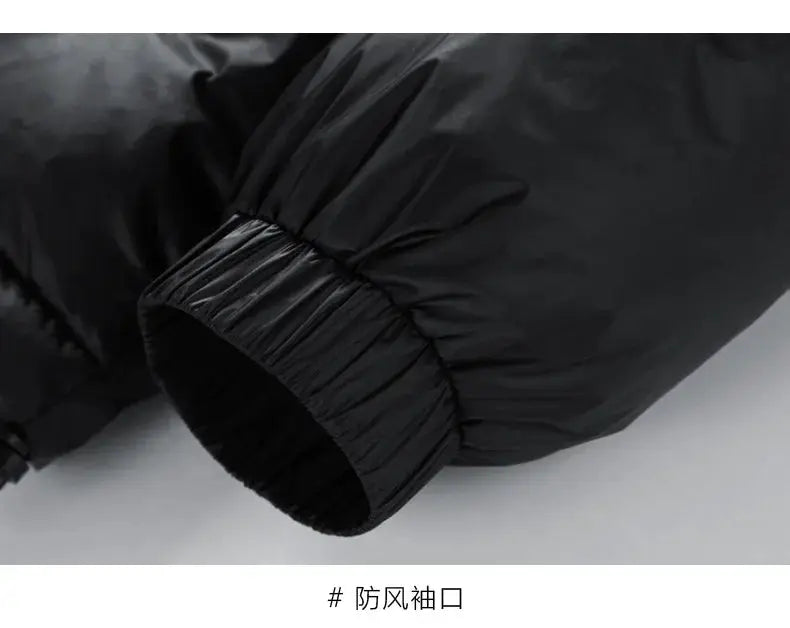 Black puffer jacket sleeve with elastic cuff; close-up of a winter down coat.