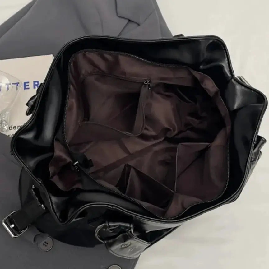 Roomy black PU leather shoulder bag with brown lining, inner pockets, large-capacity crossbody tote.