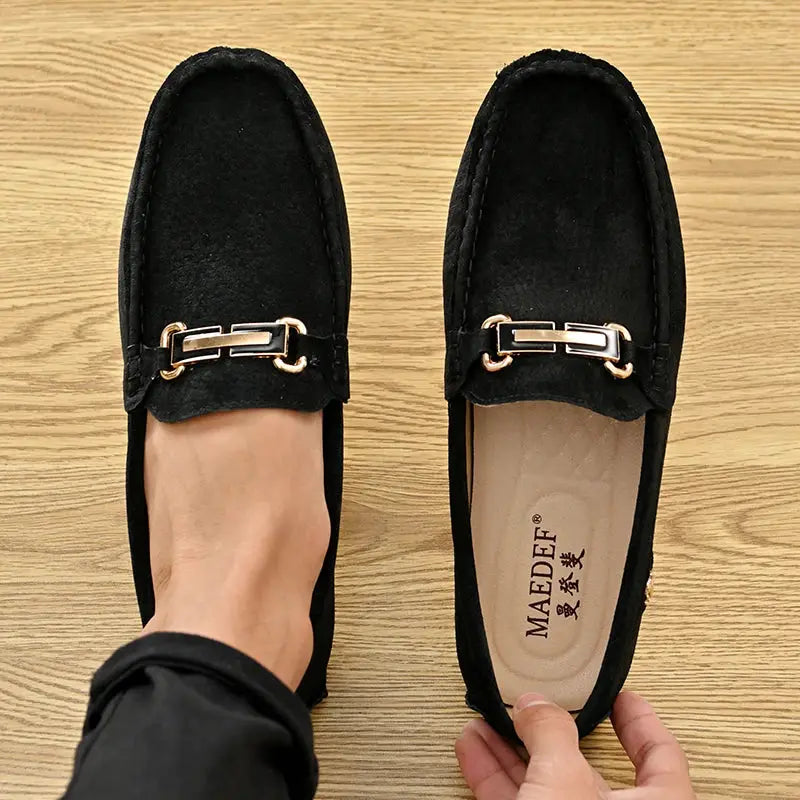 Men's black suede loafers with gold horsebit detail, slip-on driving moccasins.