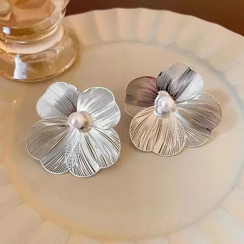 Pair of large silver flower earrings with striped petals and pearl centers.