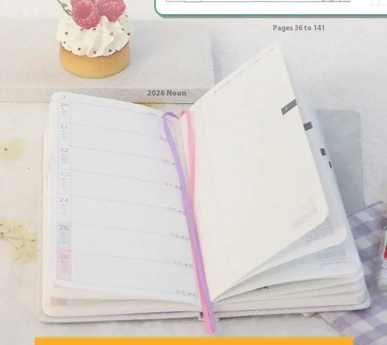 Kinbor 2026 weekly planner pocket notebook with pink and purple ribbons, open to a weekly layout