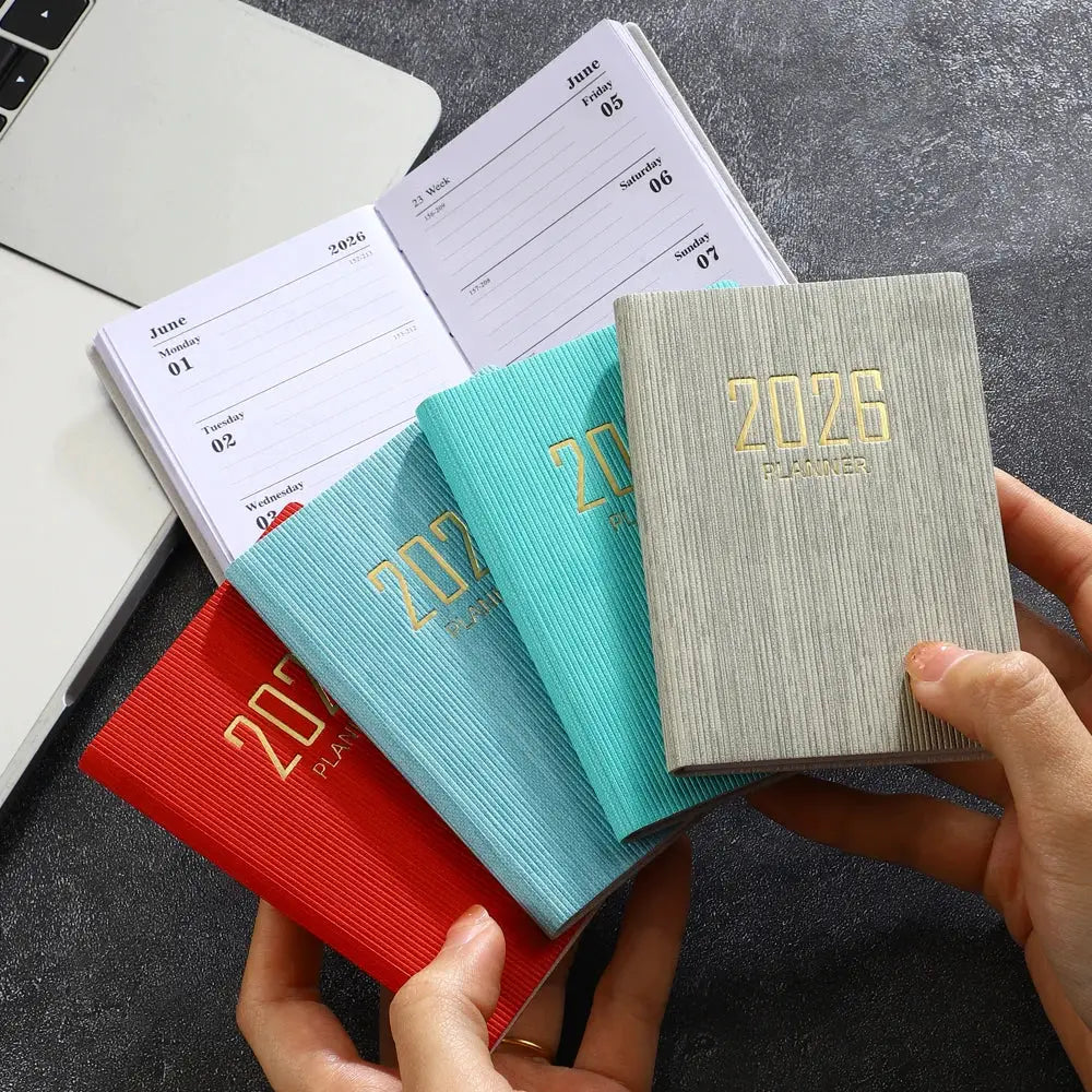 Simples Market 2026 A7 pocket planner set of four with red, teal, light blue and gray covers; 64 sheets, 128 pages