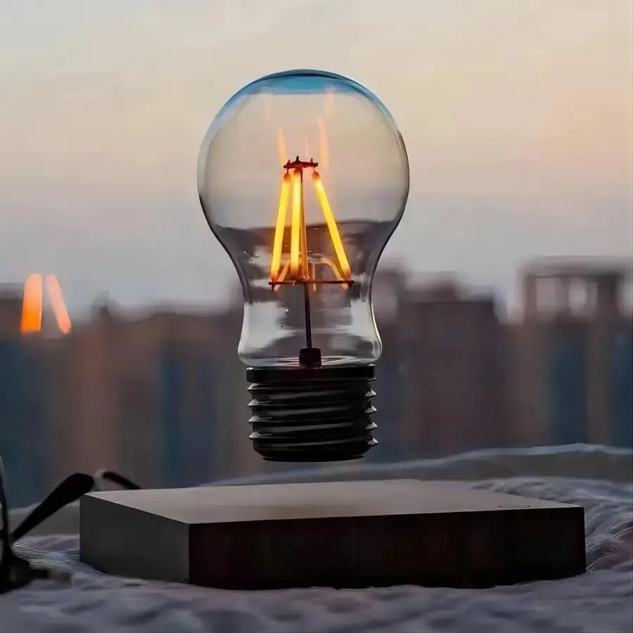 Magnetic levitation lamp with floating glass LED bulb, warm amber filament light on a black base.