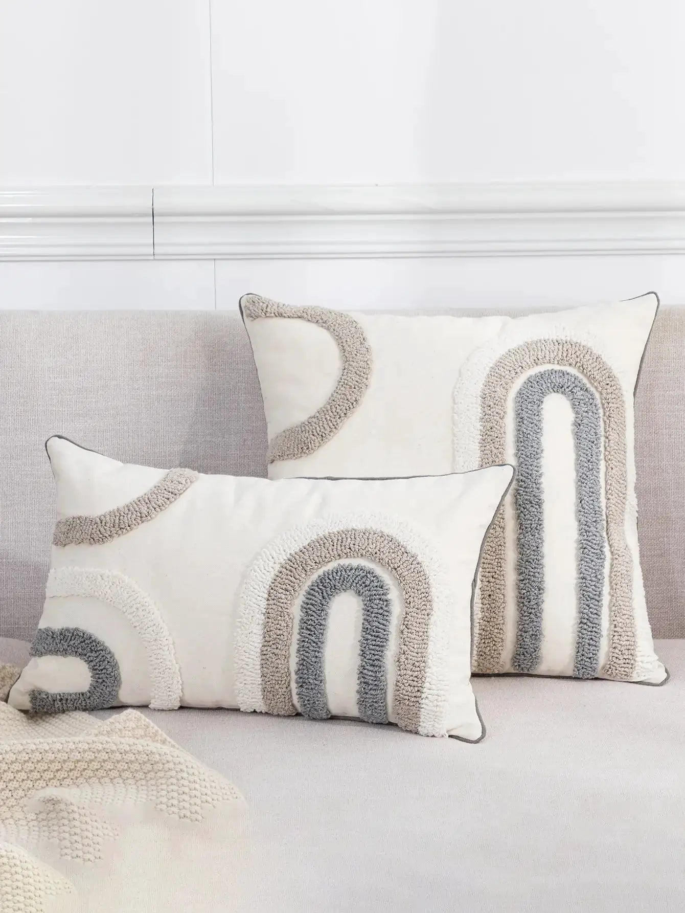 Pillow covers: three Bohemian U-shaped boucle pattern cushions in cream, beige, and gray on a light sofa