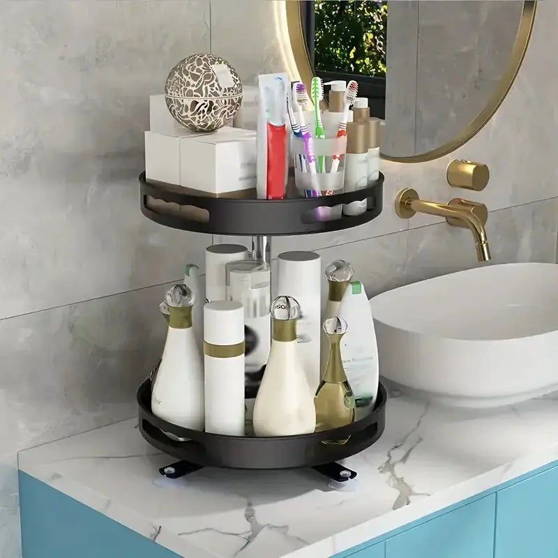 Two-tier 360° rotating black non-slip storage rack on a countertop, holding cosmetics, toothbrushes and bottles.