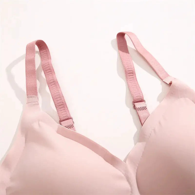 Pink women's seamless bra with adjustable straps and soft cups.