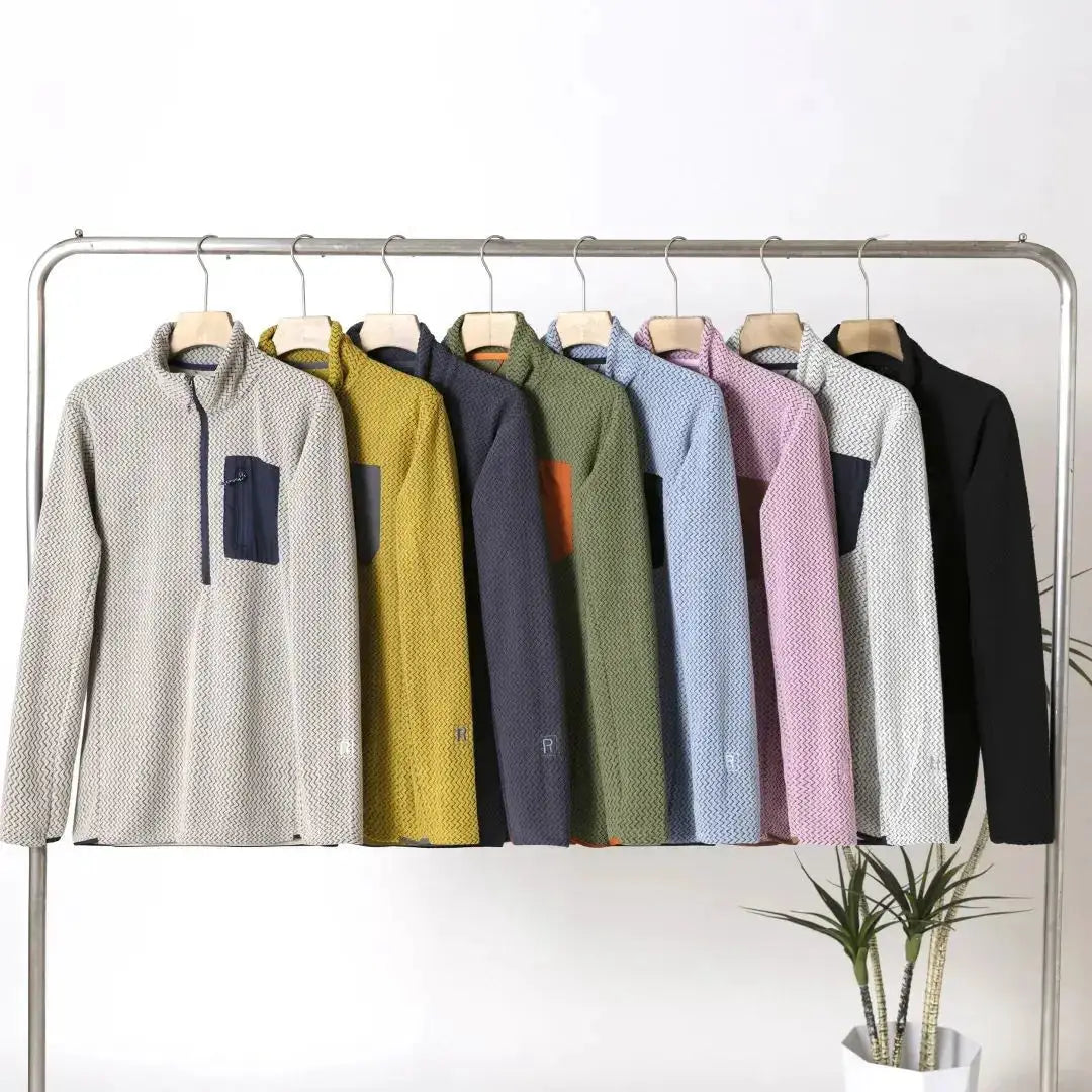 Semi-zip fleece sweatshirts with wavy texture in a multicolor assortment on a clothing rack