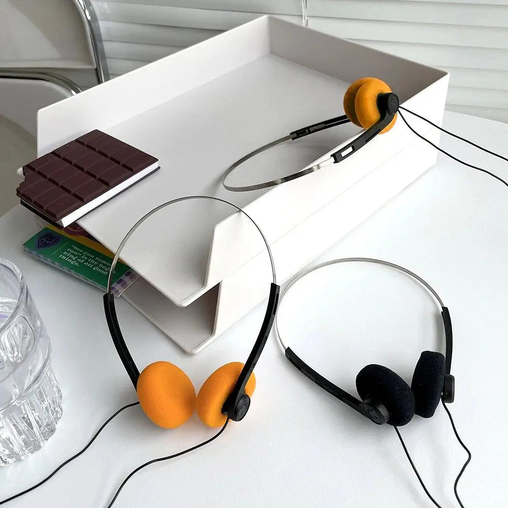 On-ear wired stereo headphones with adjustable headbands; orange and black foam ear pads (2 pairs)
