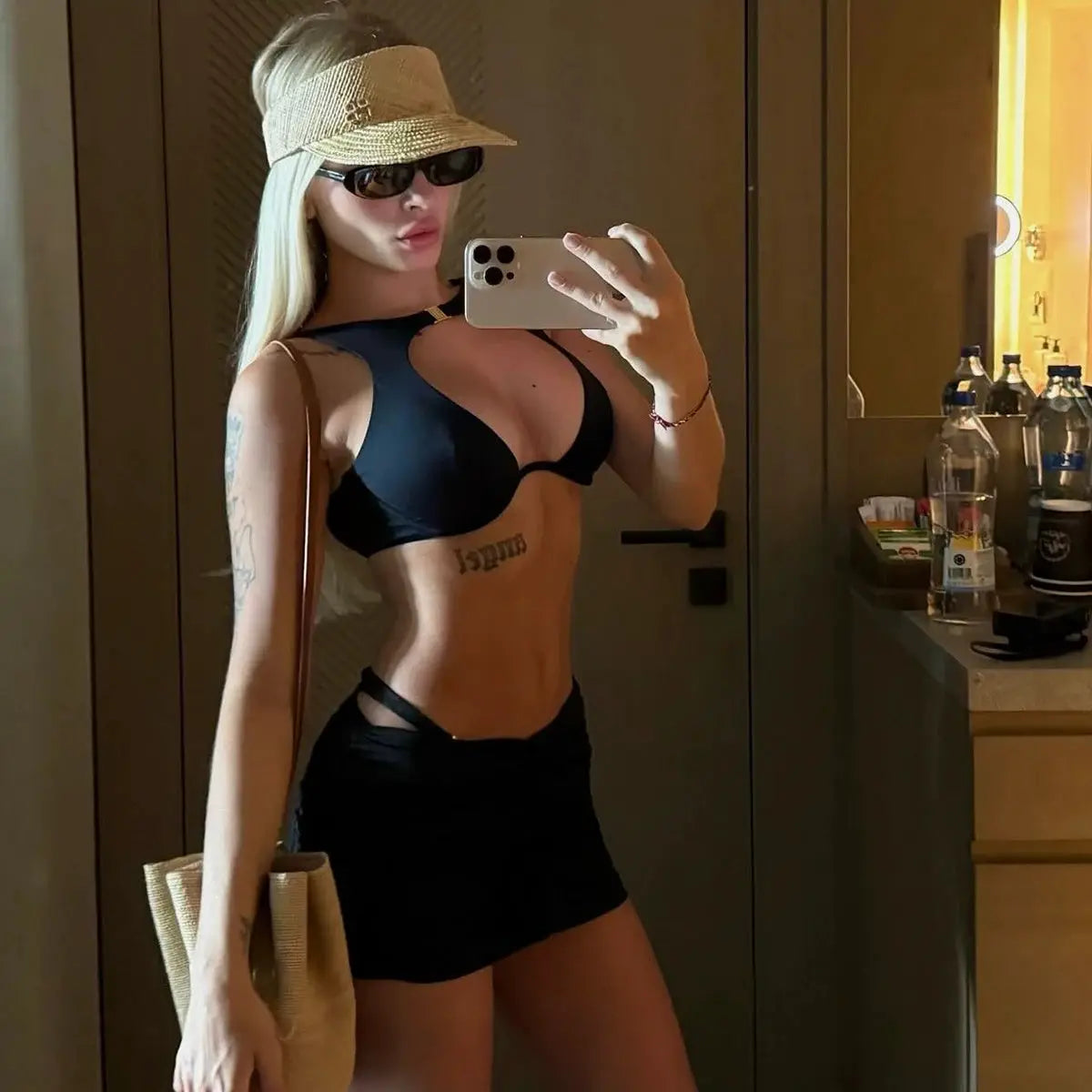 3-piece black bikini set with push-up top and matching miniskirt, model wearing a straw hat and sunglasses in a mirror selfie