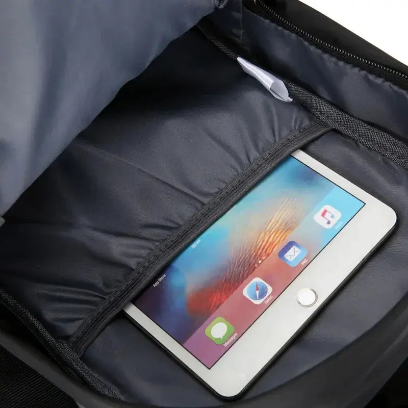 Men's chest bag, large canvas crossbody in black Oxford cloth with front zip pocket holding a tablet