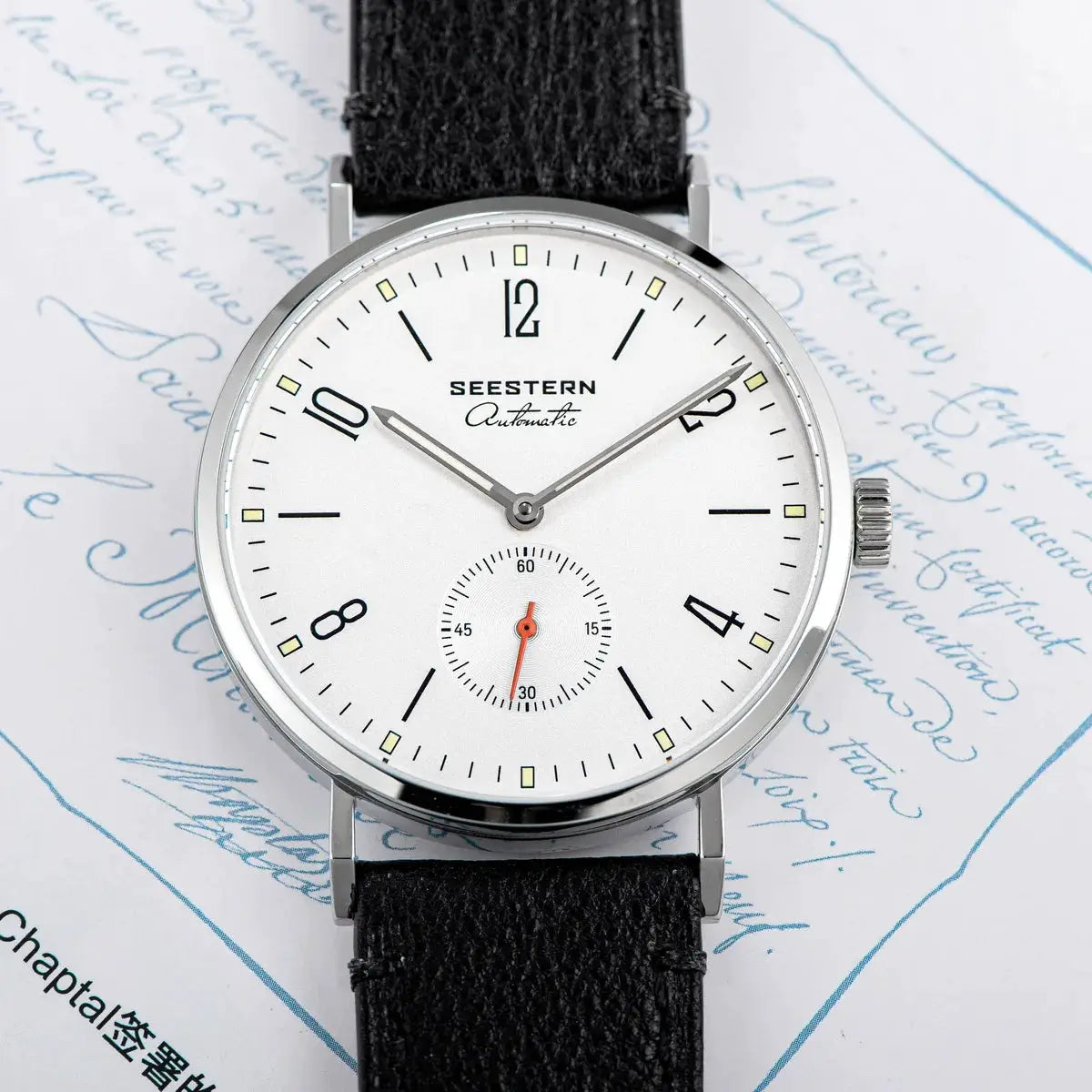 Seestern men's automatic wristwatch, white dial with small seconds subdial, silver case, black leather strap.