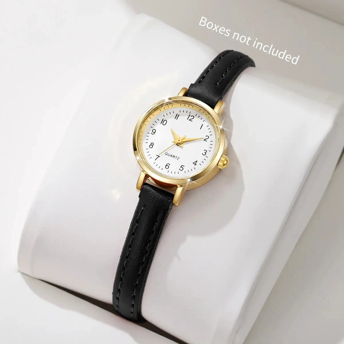 Women quartz wristwatch with black leather strap, gold-tone case, white Roma dial.