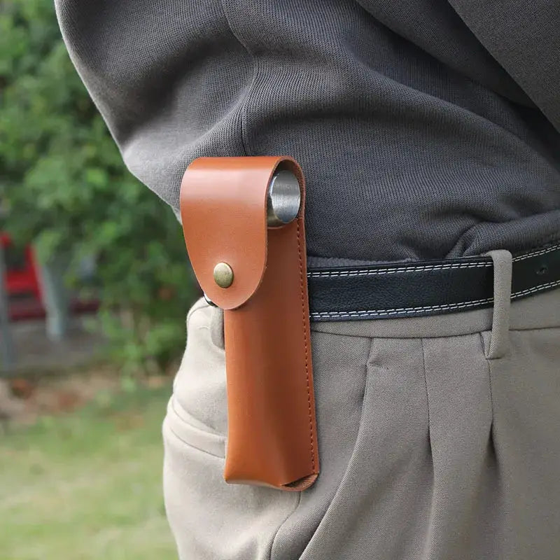 Auger wrench in brown leather sheath holster worn on belt