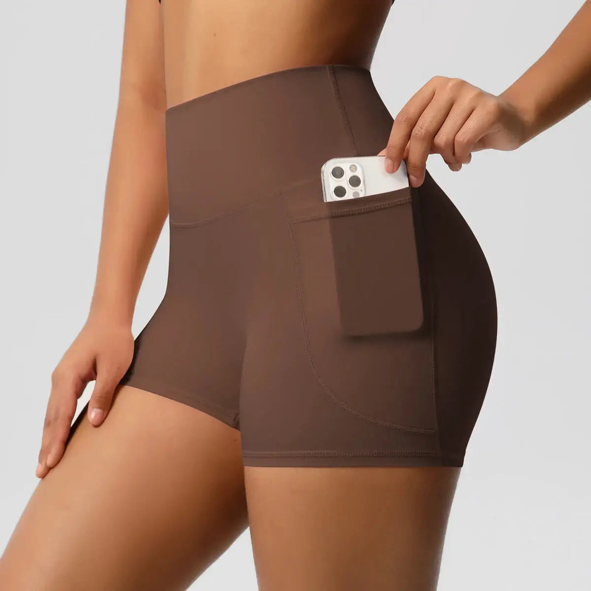 Women’s brown high-waist pocketed athletic shorts with side phone pocket