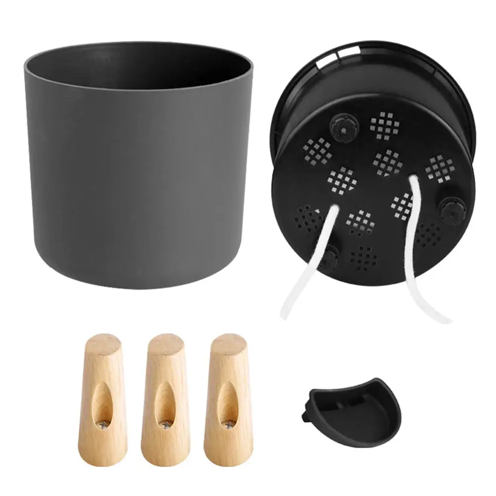 Floor-standing round plant pot with gray body, wooden legs, and self-watering drainage system; includes 3 legs.