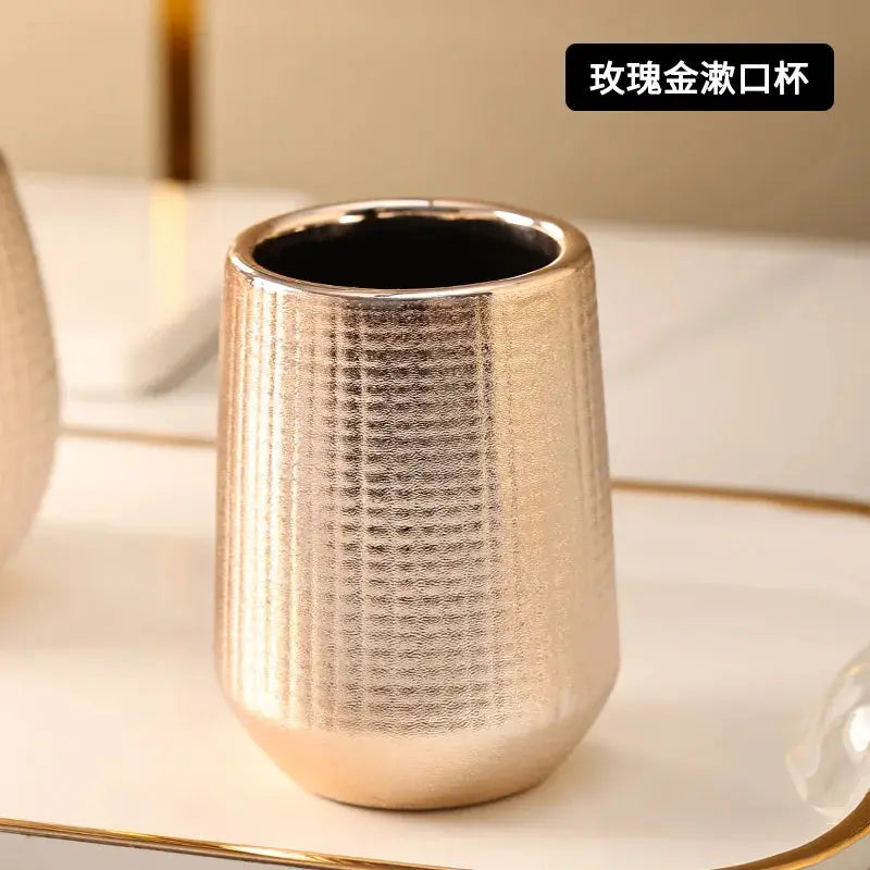 Rose gold ceramic bathroom cup by Simples Market, part of a hotel-style bathroom accessories set