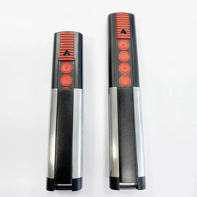Two Sommer 4020 TX03-868-4 garage door remote controllers with red circular buttons and silver rails