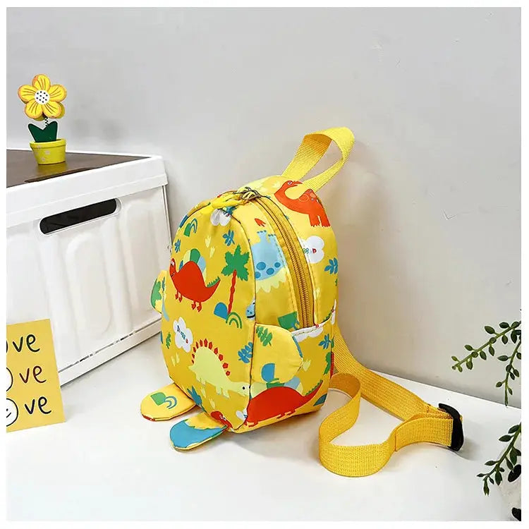 Kids yellow dinosaur backpack with cartoon print and matching yellow straps