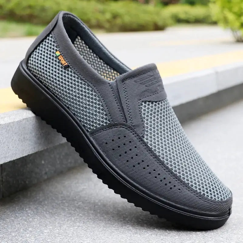 Men's breathable slip-on casual shoes with gray mesh fabric and black rubber sole, low-top.