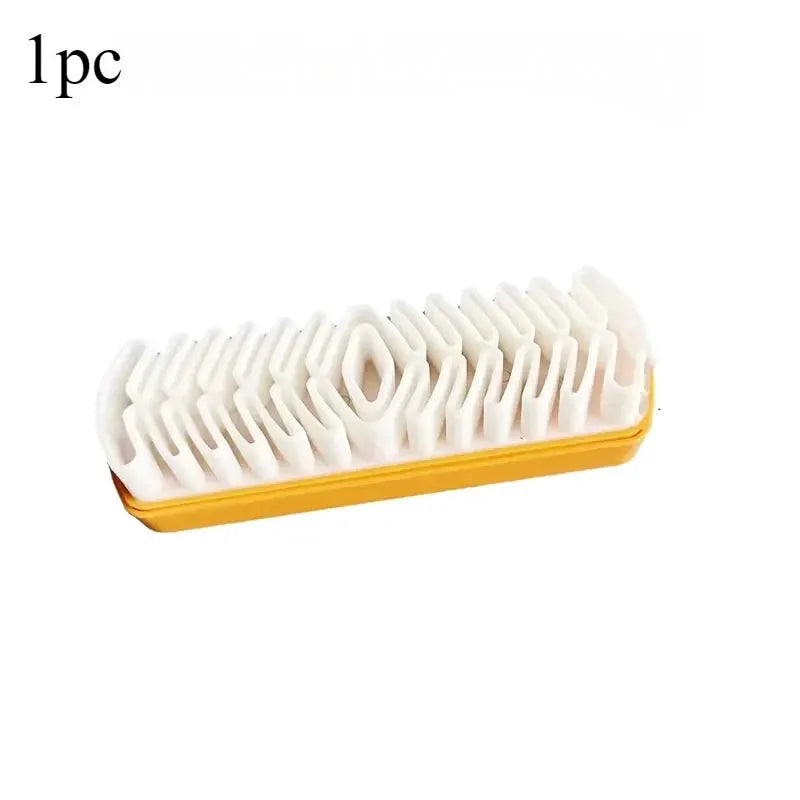 Suede cleaning brush with white bristles and yellow plastic base