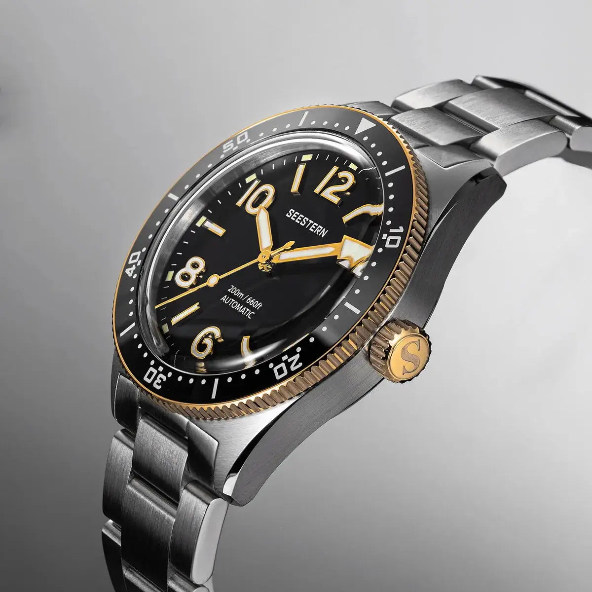 SEESTERN Diver Mens Watch, automatic NH35A, black dial with gold numerals, gold bezel, stainless steel bracelet