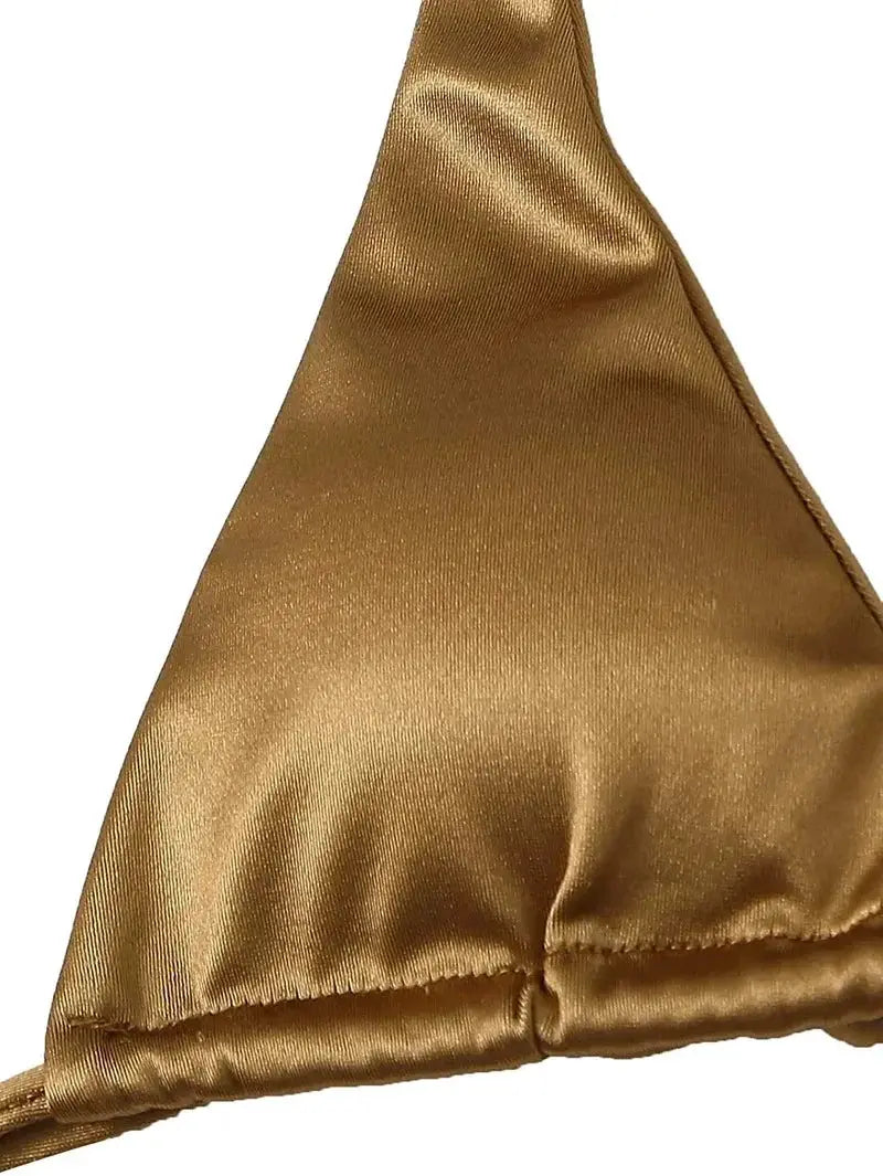 Halter bikini top in gold metallic satin with close-up fabric texture