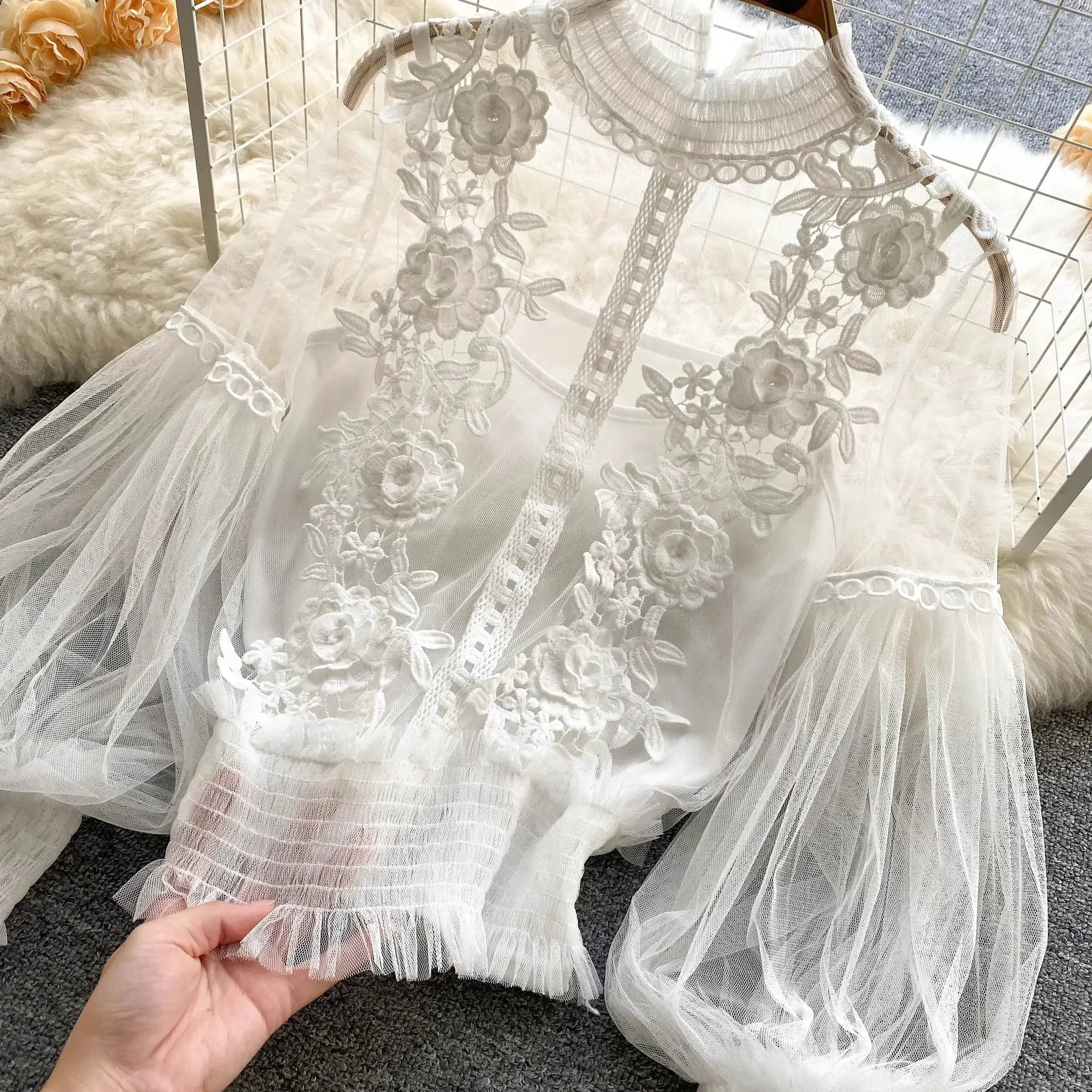 Lace puff long sleeve blouse in white with floral embroidery and sheer tulle sleeves.