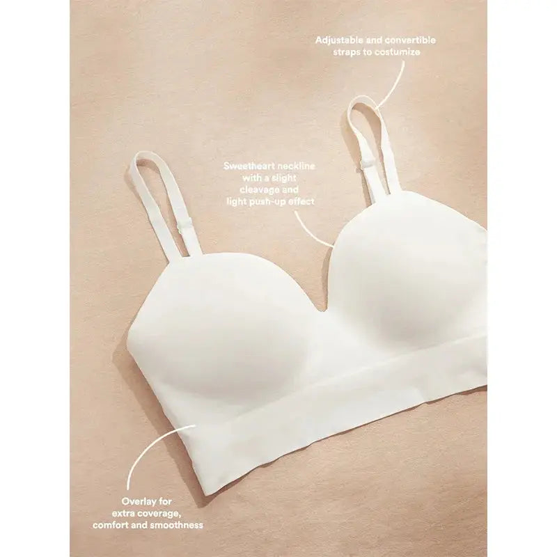 Plus-size white wireless bra with fixed cups and adjustable straps.