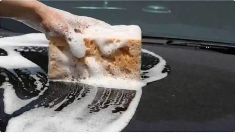 Car wash sponge block with brown honeycomb texture, large size, lathering soapy foam on a car hood