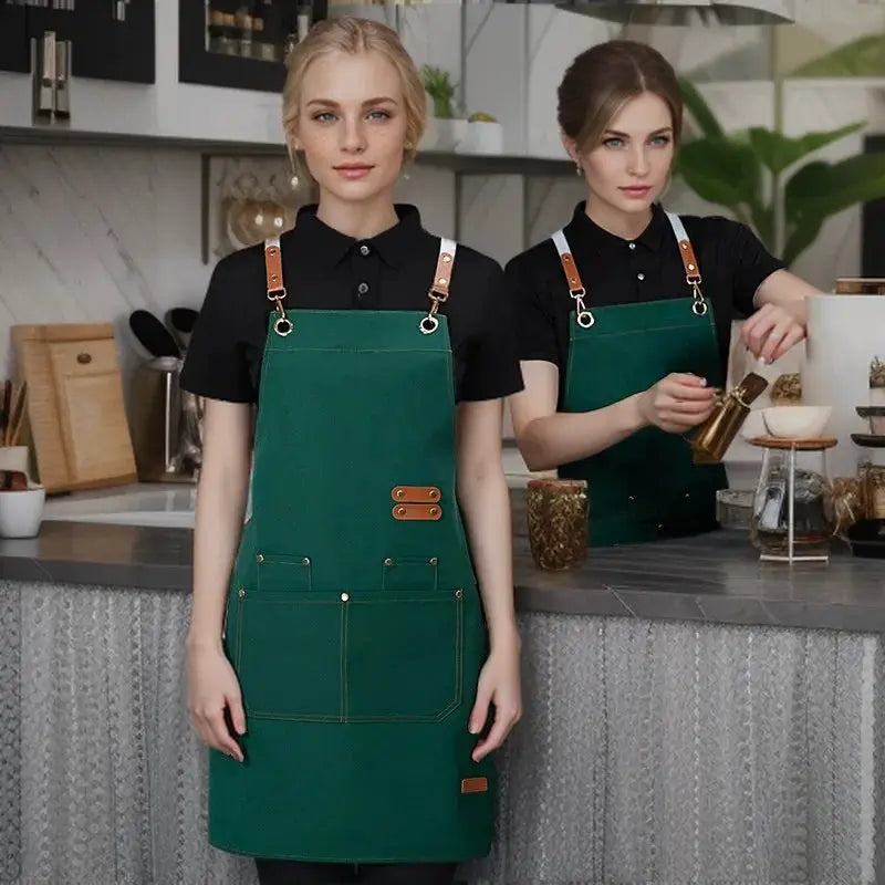Simples Market waterproof kitchen apron green pinafore with brown leather straps and pockets, worn by two models