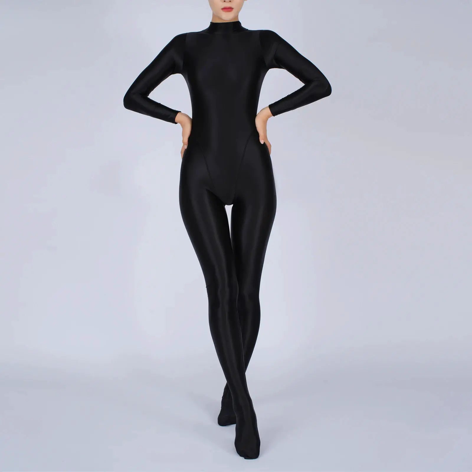 Women's black glossy full-body jumpsuit with long sleeves, footed one-piece athletic wear.