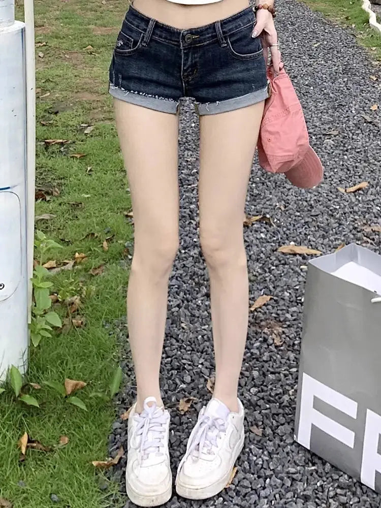 Denim shorts for women in dark blue with elastic low waist, slim fit, rolled cuffs