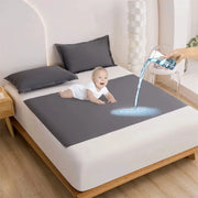 Simples Market TPU waterproof bed flat sheet in gray on a bed with a baby