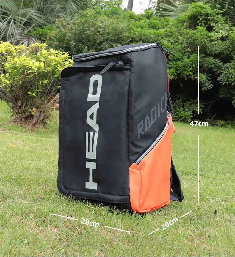 HEAD Radical tennis backpack, black with orange side pocket, HEAD logo and Radical text
