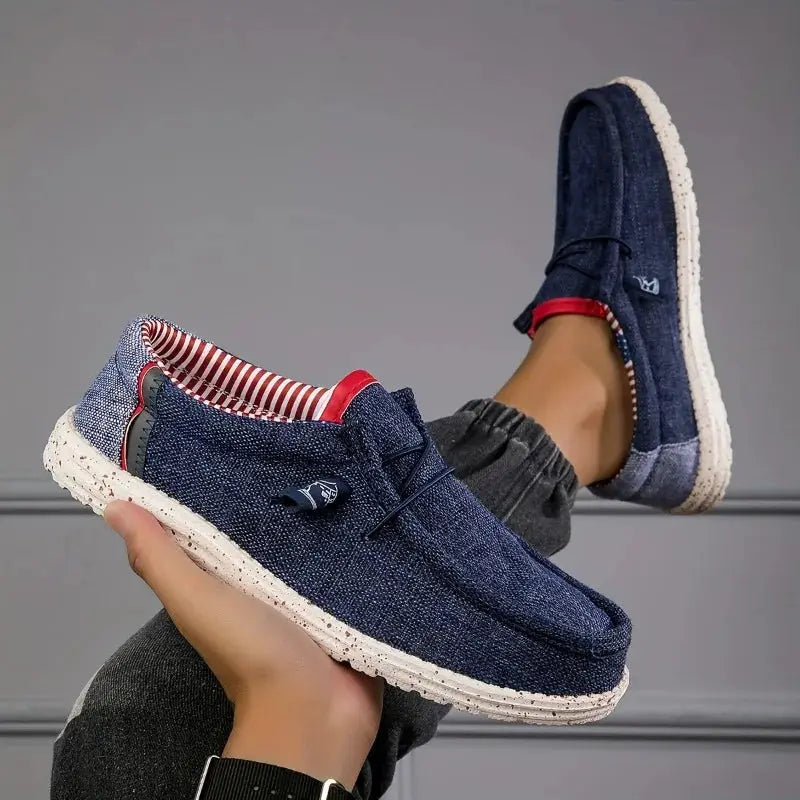 Men's navy denim canvas loafers by Simples Market with white speckled sole and red striped lining.