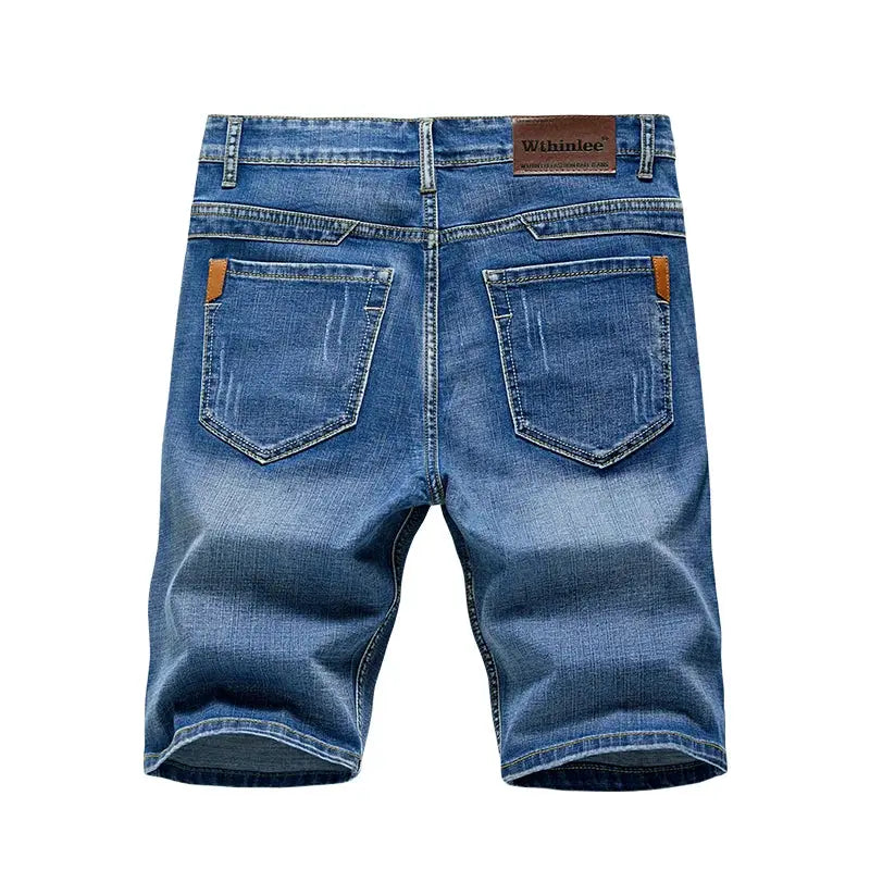 Men's slim-fit denim shorts in blue stretch denim with back pockets and brown brand patch