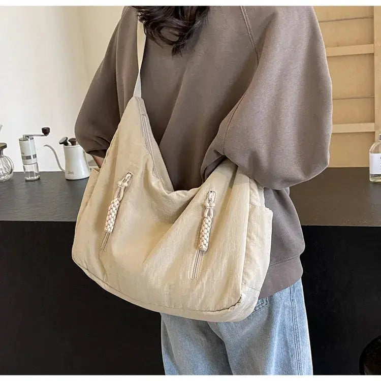 Trendy women's large beige soft cloth shoulder bag with beaded tassel zipper pulls