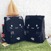 Two black cat-ear backpacks with 3D faces, large-capacity girls' cartoon book bags with paw-print front pockets.
